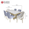 Comedor de seis puestos con sillas tapizadas en gris y beige, patas doradas y mesa con tablero marmoleado